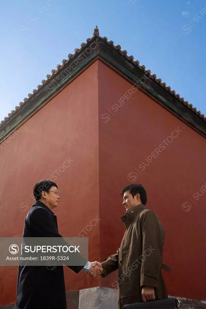Businessmen Shaking Hands Standing Next To Traditional Architecture, ,
