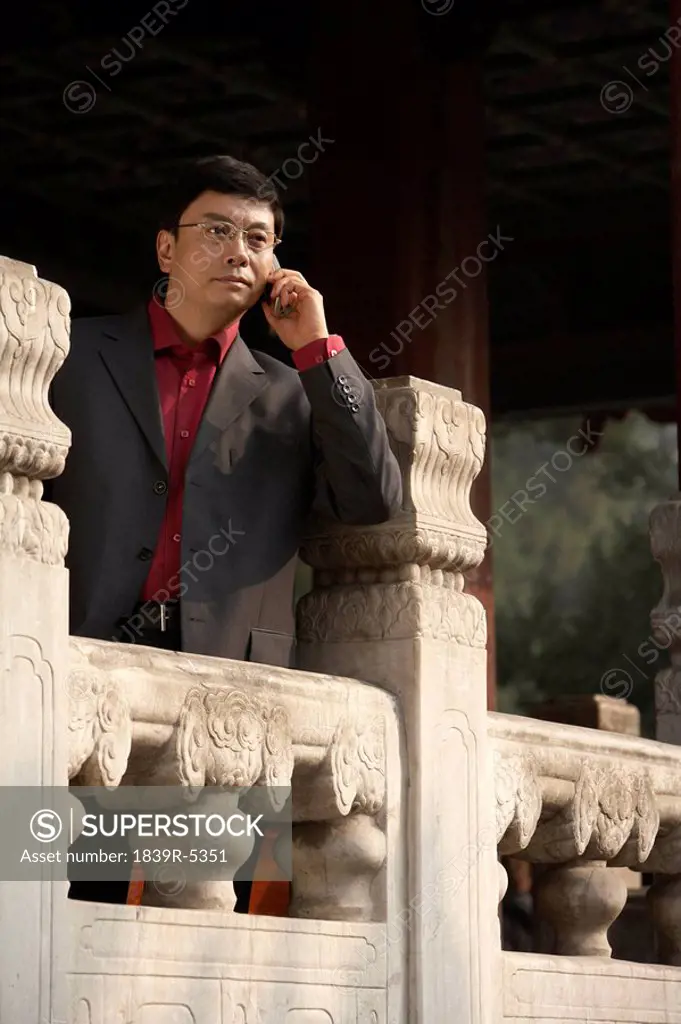 Businessman Talking On Cellphone In The Forbidden City In Beijing