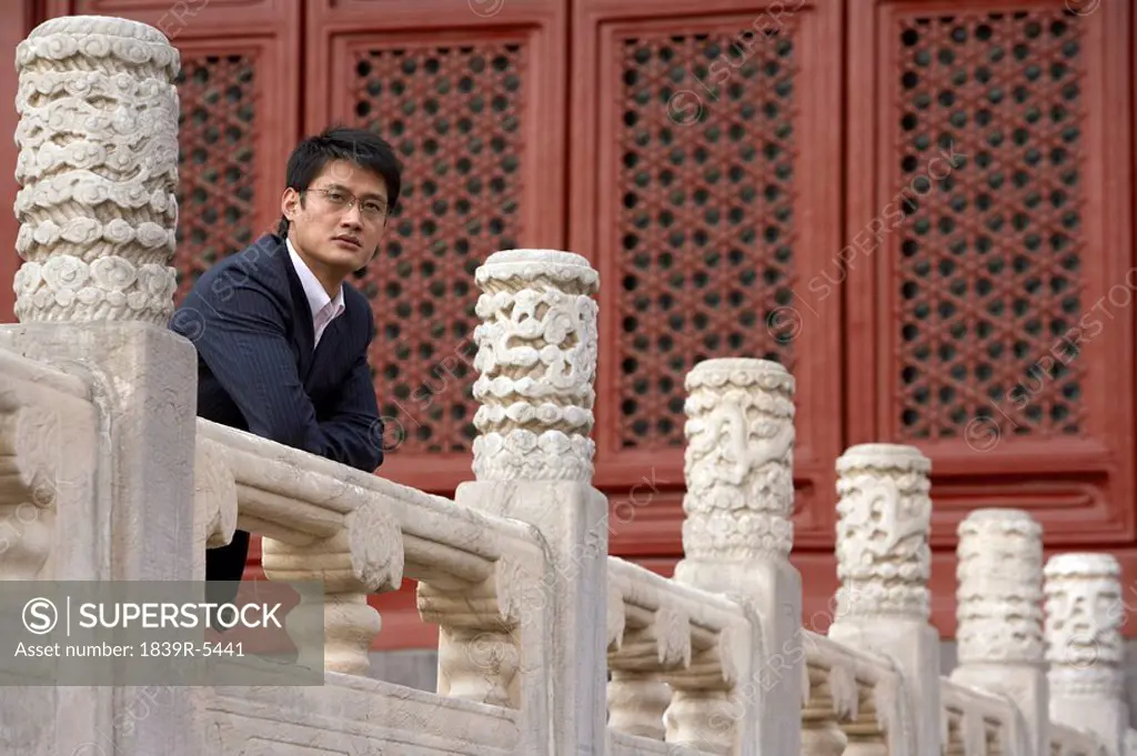 Businessman Leaning On A Rail In The Forbidden City In Beijing