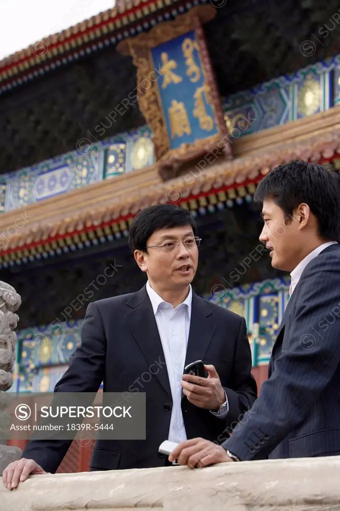 Two Businessmen Talking In The Forbidden City In Beijing