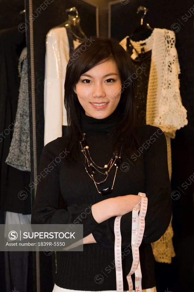 Young Woman Holding A Measuring Tape In A Shop Store