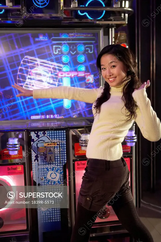 Teenage Girl On Dancing Game At Arcade