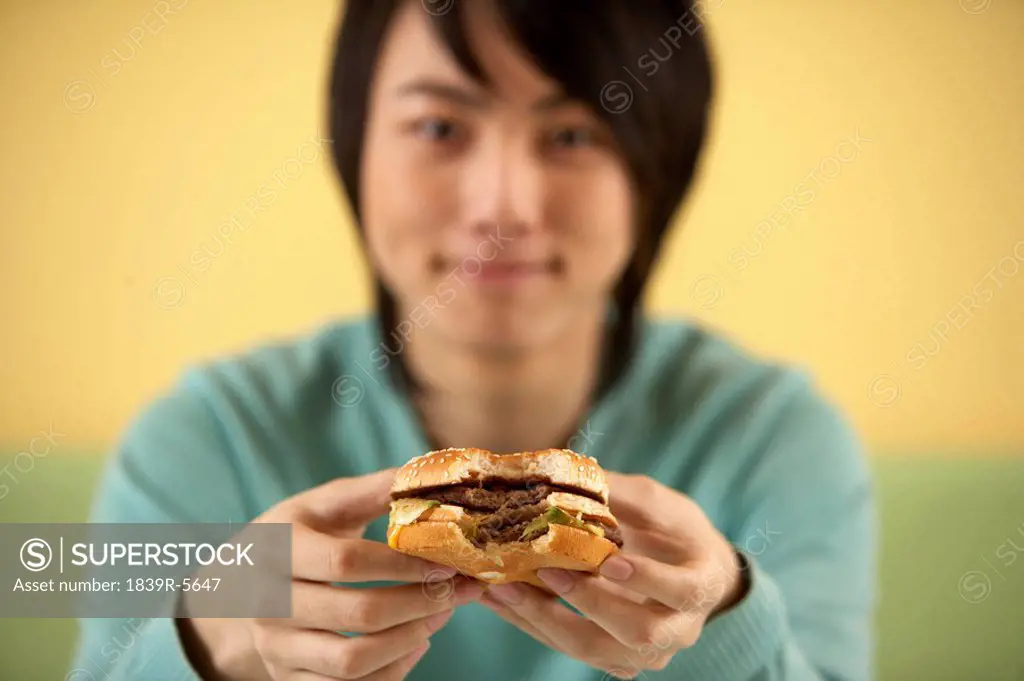Teenage Boy Eating Hamburger