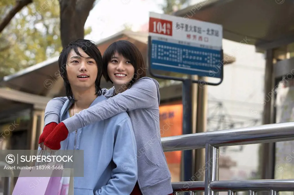 Young Couple Waiting At A Bus Station