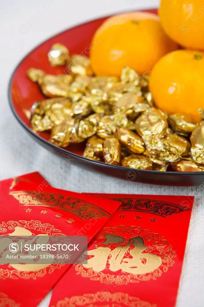 Red Packets Containing Monetary Gifts, With Mandarin Oranges And Sweets