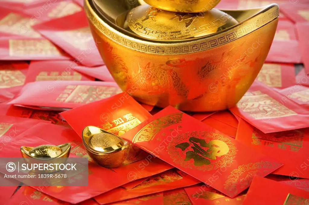 Gold Yuanbao Ingot Symbolizing Wealth And Red Packets Containing Monetary Gifts