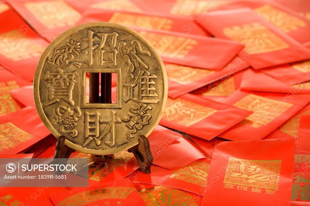 Lucky Chinese Coin And Red Packets Containing Monetary Gifts