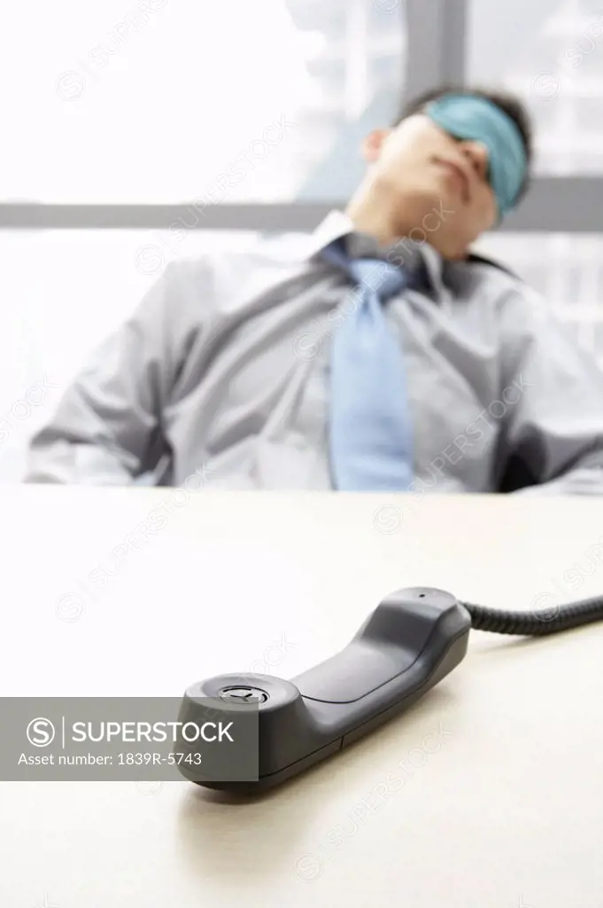 Phone Off Hook While Businessman Sleeps
