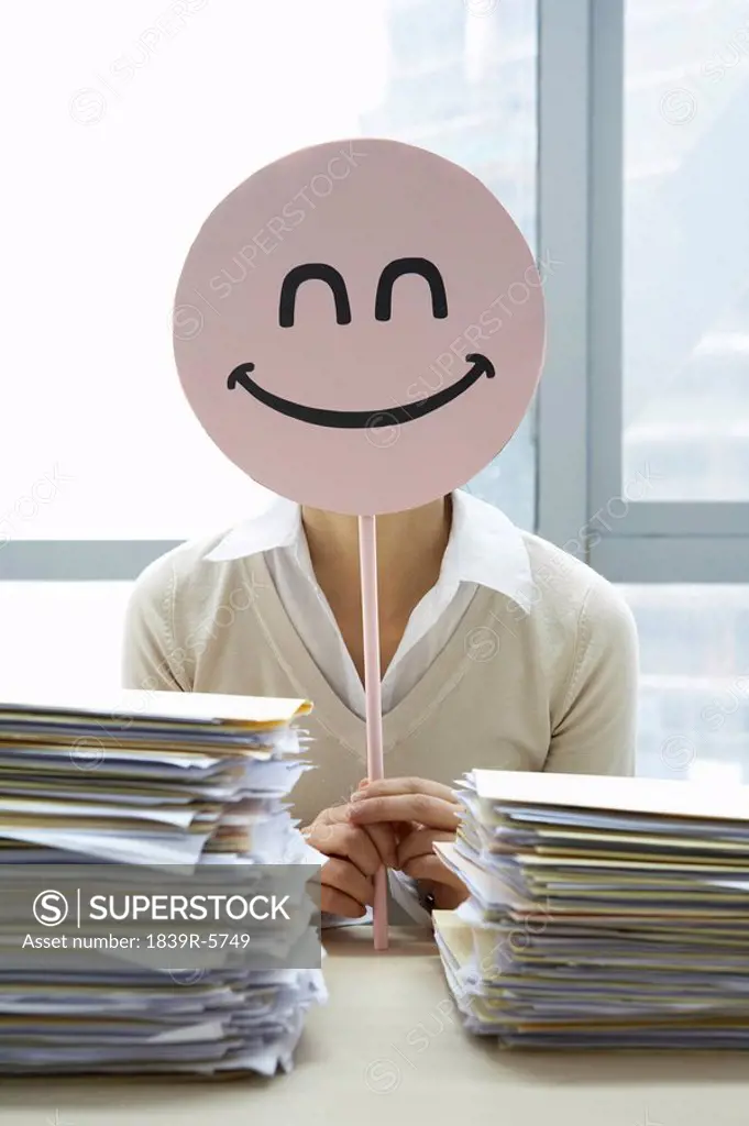 Businesswoman With Smiley_Face Sign
