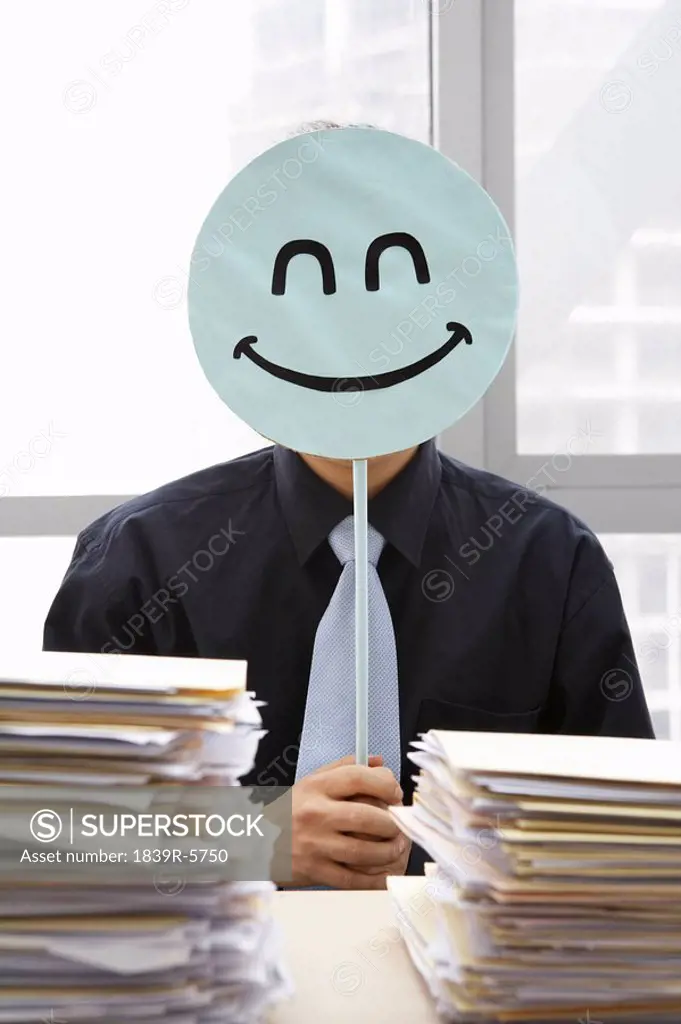 Businessman With Smiley_Face Sign