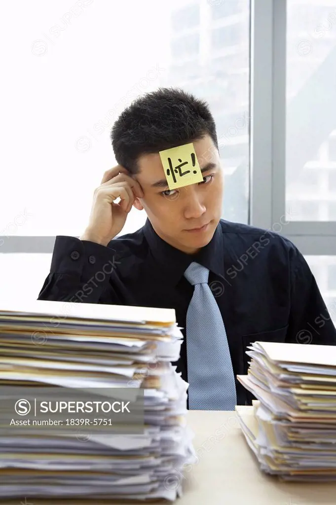 Businessman With Sticky_Note On Forehead