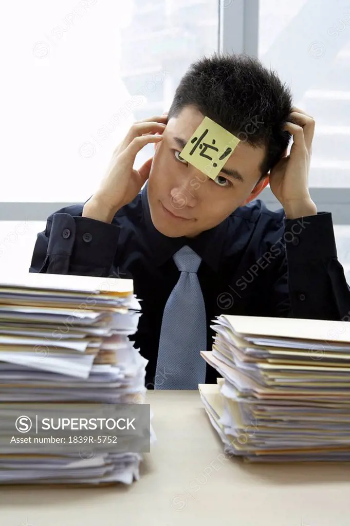 Businessman With Sticky_Note On Forehead