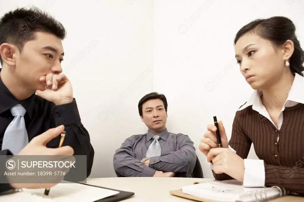 Businesspeople Having A Discussion In A Board Room