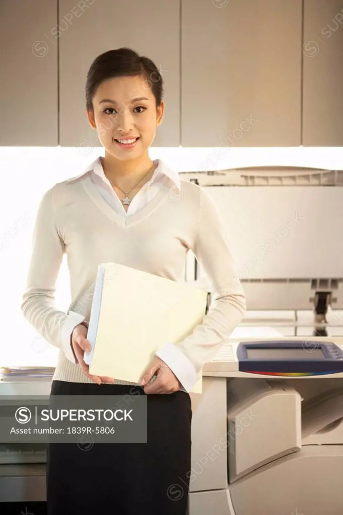 Young Woman Next To Photocopier