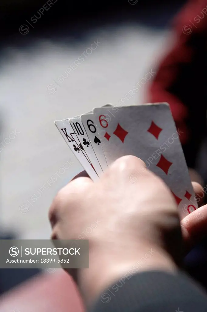Close Up Of A Hand Holding Cards