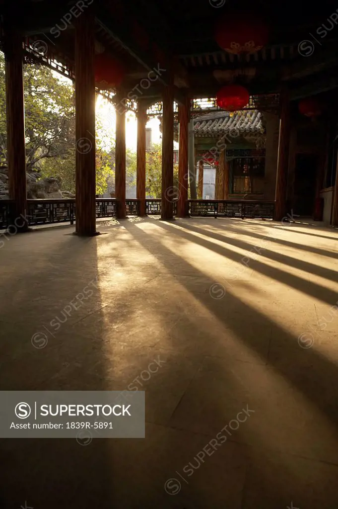 Sun Streaming Through Columns Onto A Courtyard