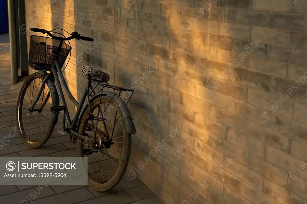 A Vintage Bicycle Leaning Against A Wall