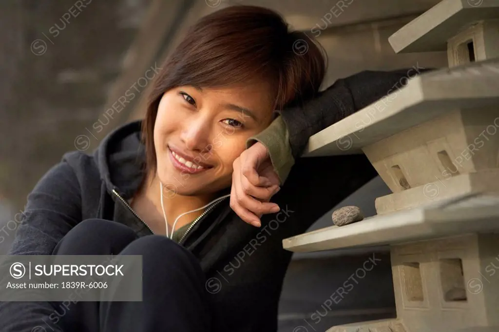 Young Woman In Sportswear Listening To Headphones