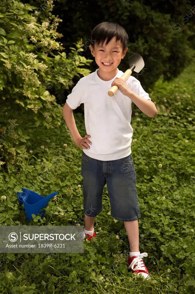 Young Boy Holding Spade, Smiling
