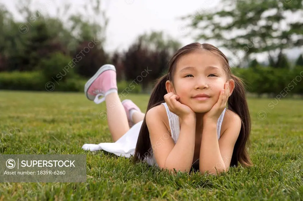 Young Girl Laying In Park
