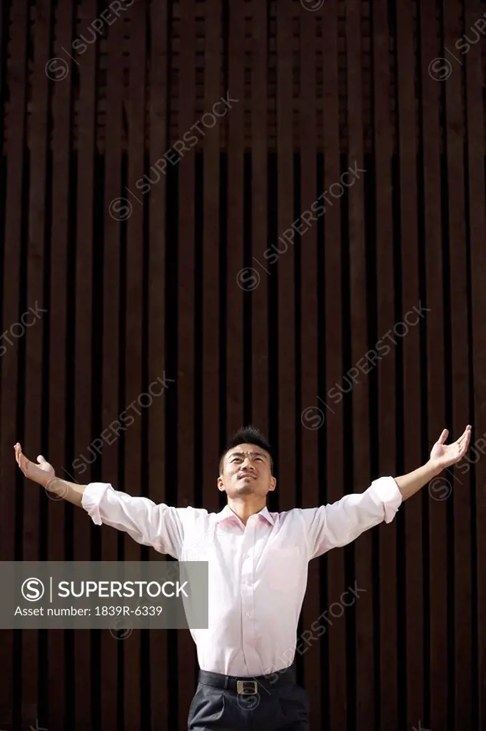 Man Standing Outdoors In Meditation Pose