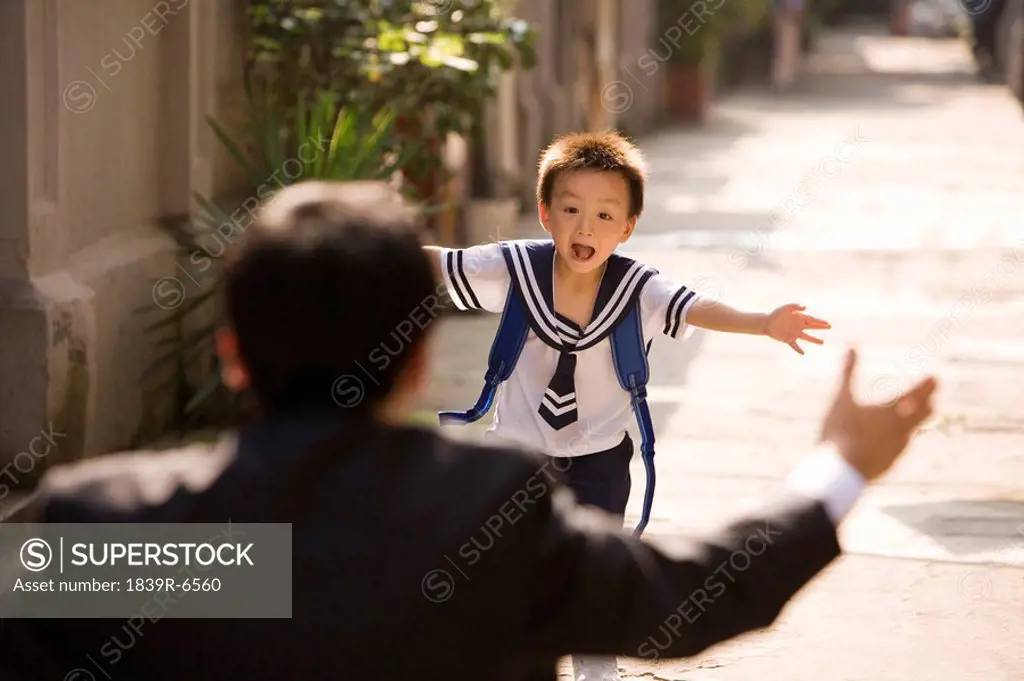 A father picks his son up from school