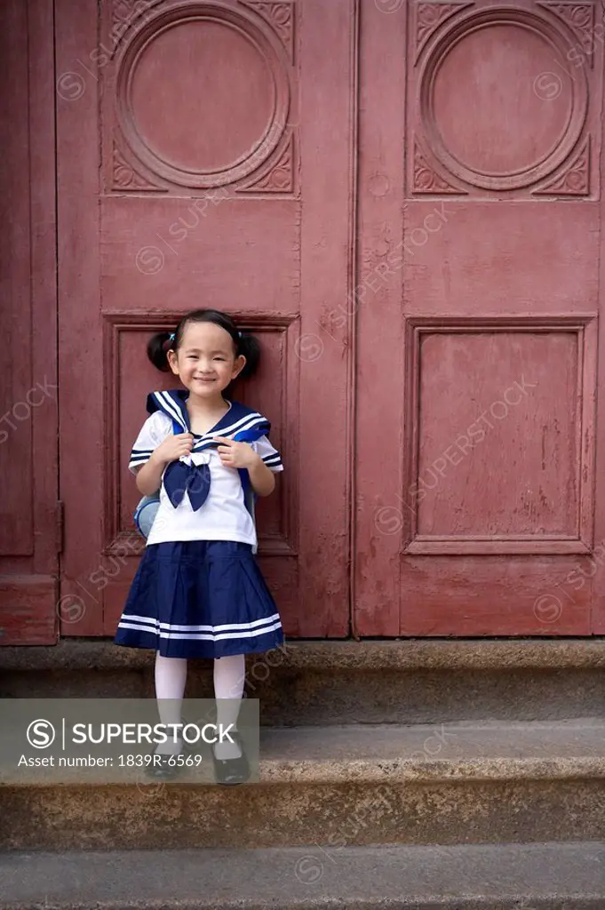 A child in her school uniform