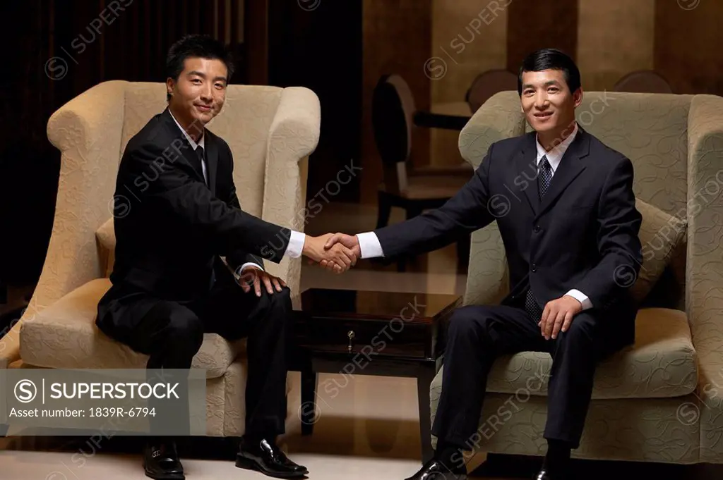 Two business leaders shake hands at an exclusive business club
