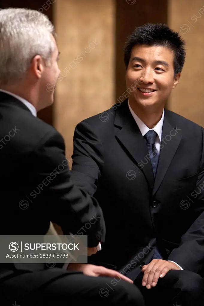 Two business leaders shake hands at an exclusive business club