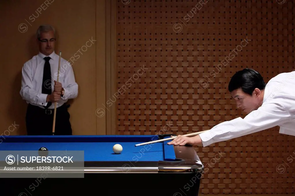 Two professionals play billiards