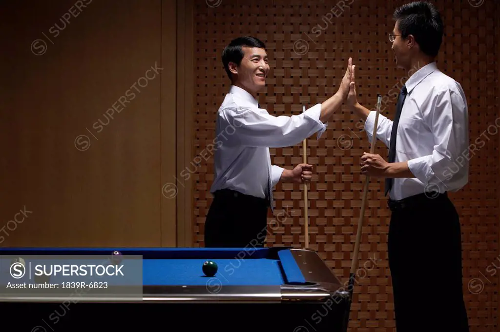 A high five at the billiards table