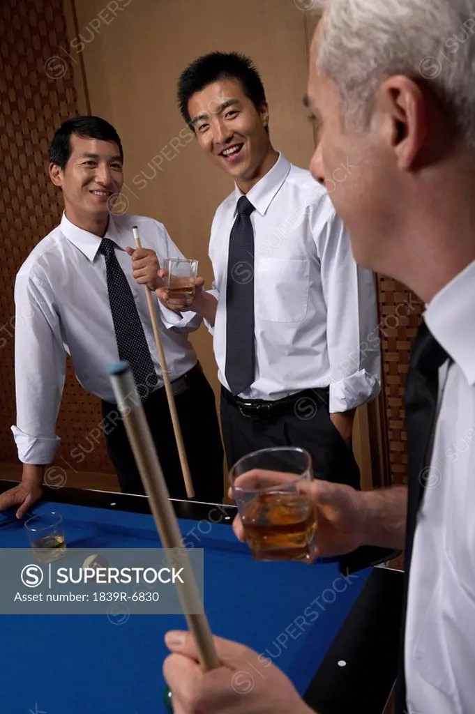 Professionals toast over billiards