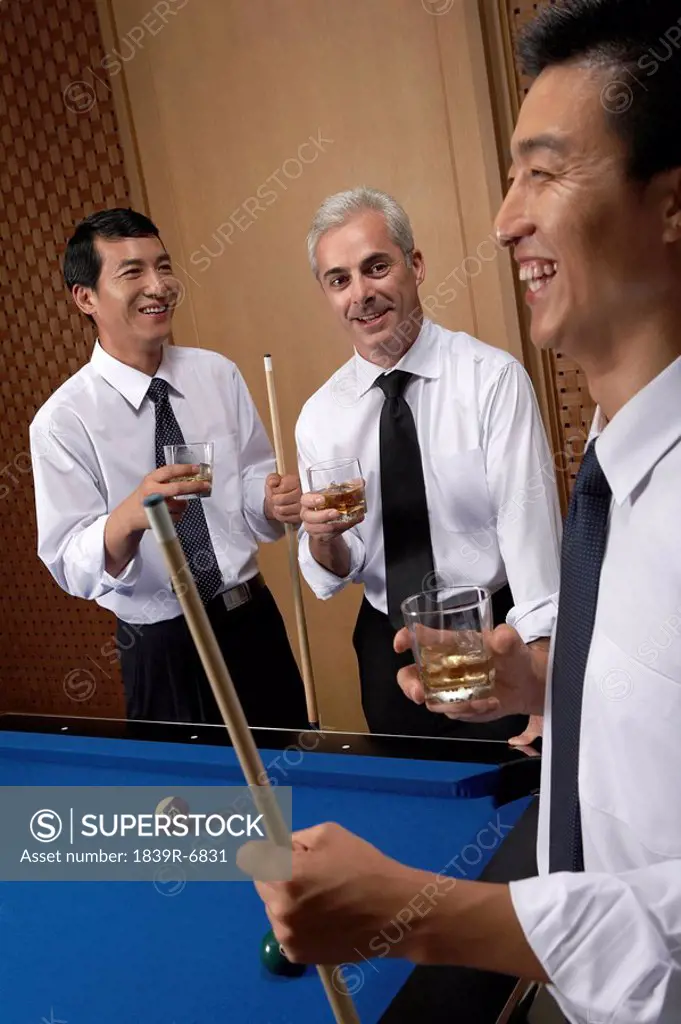 Professionals toast over billiards