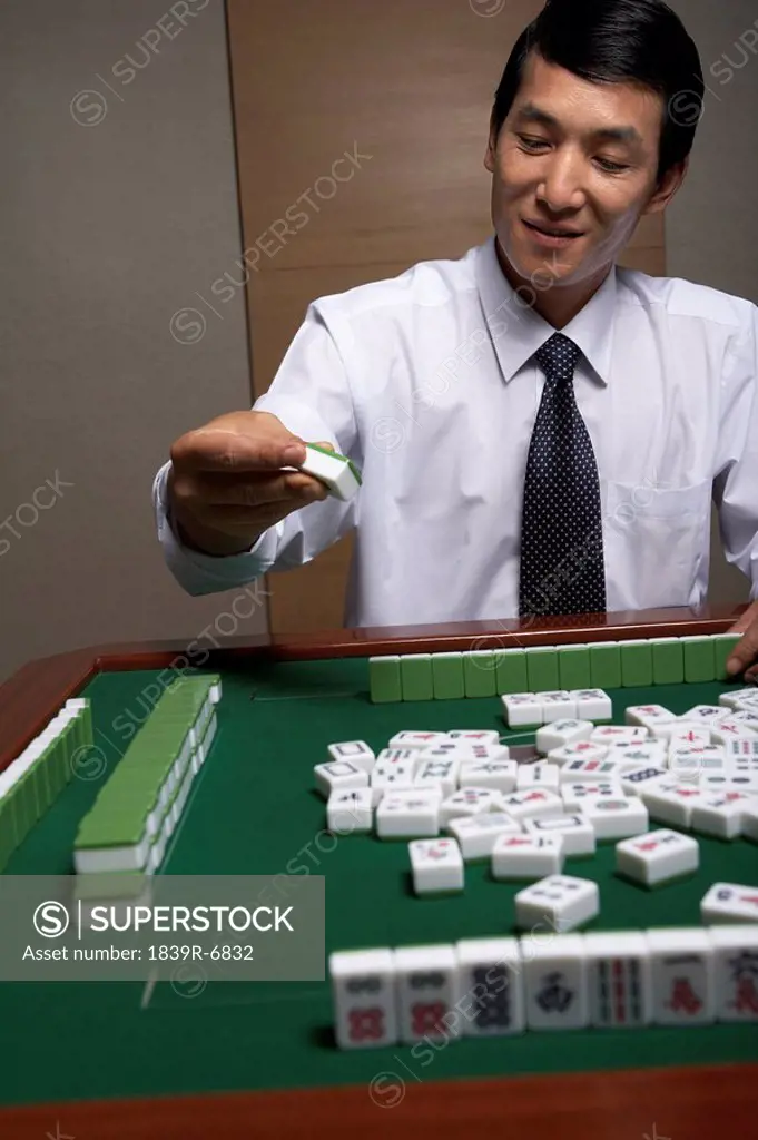 A businessman plays Mahjong