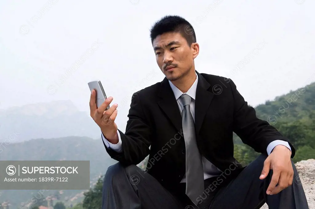 A businessman uses his cell phone