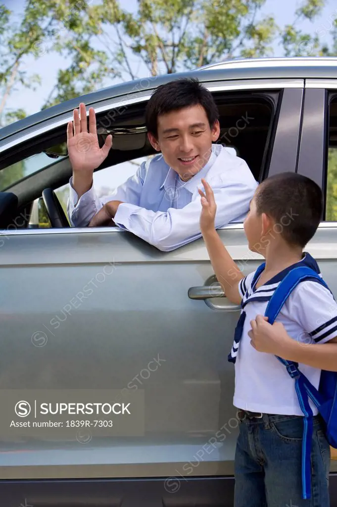 Father dropping son off at school