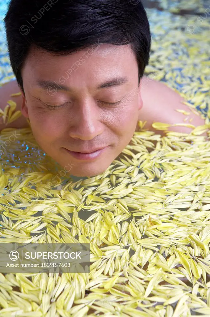 Man relaxing in a flower bath