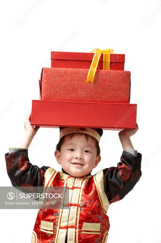 A young boy carrying presents for Chinese New Year
