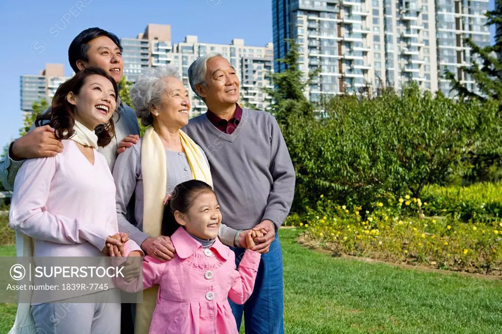 A three generational family looks off at a new home