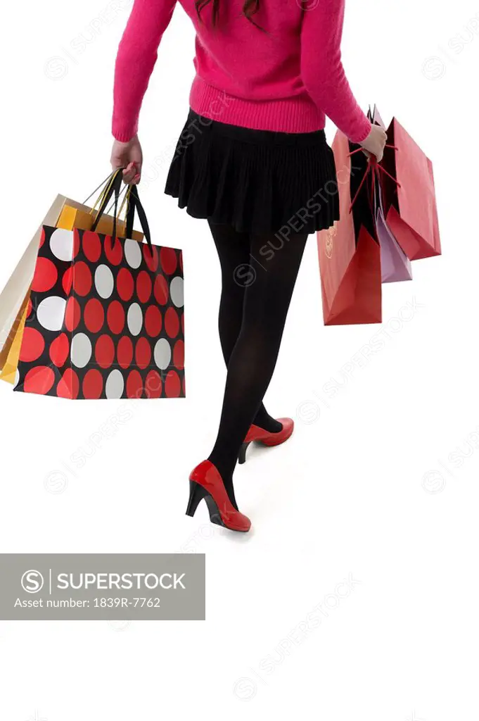 High angle view of a woman walking with shopping bags