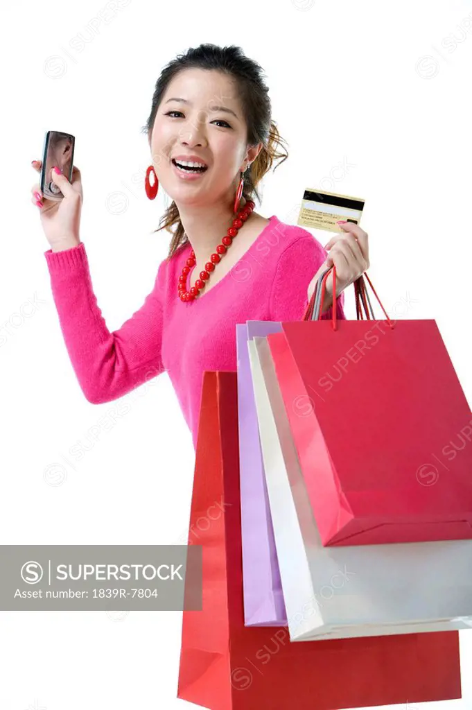 Young woman with her mobile phone and credit card