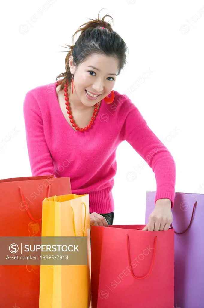 Young woman looking through shopping bags