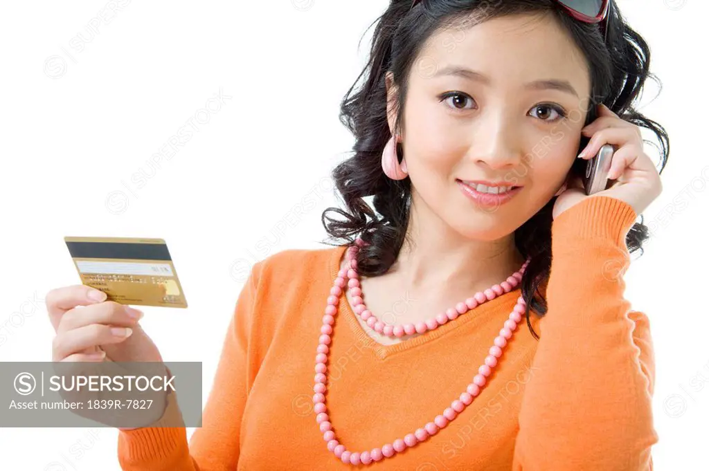 Young woman with credit card and mobile phone