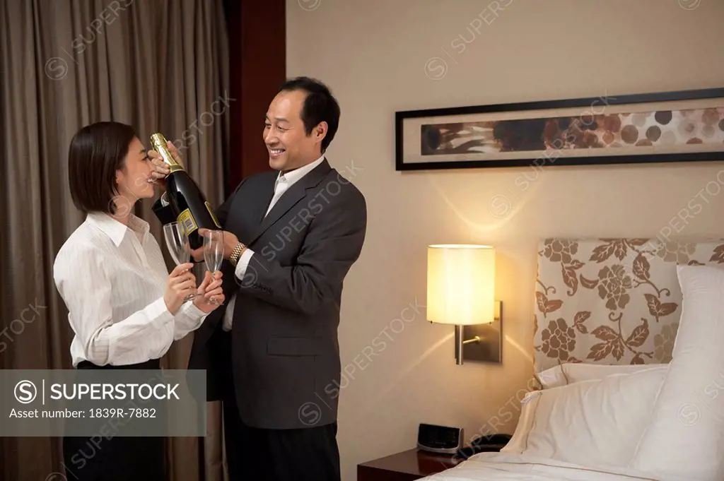 Man and woman celebrating with champagne