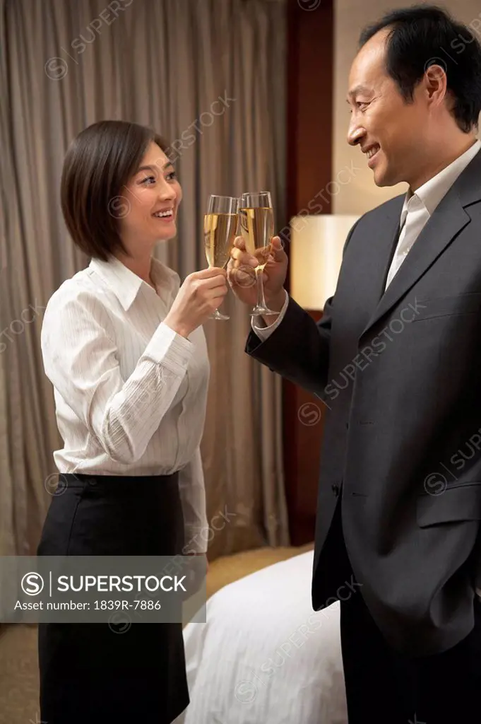 Man and woman having champagne together