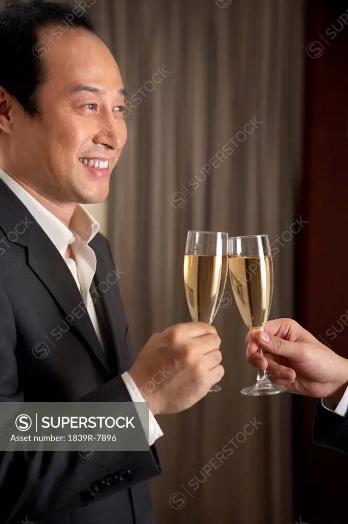 Man toasting woman with champagne