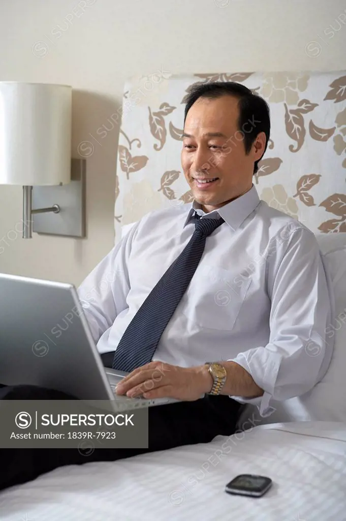 Man in shirt and tie with laptop