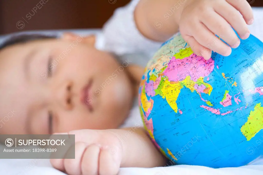 Infant sleeping with globe