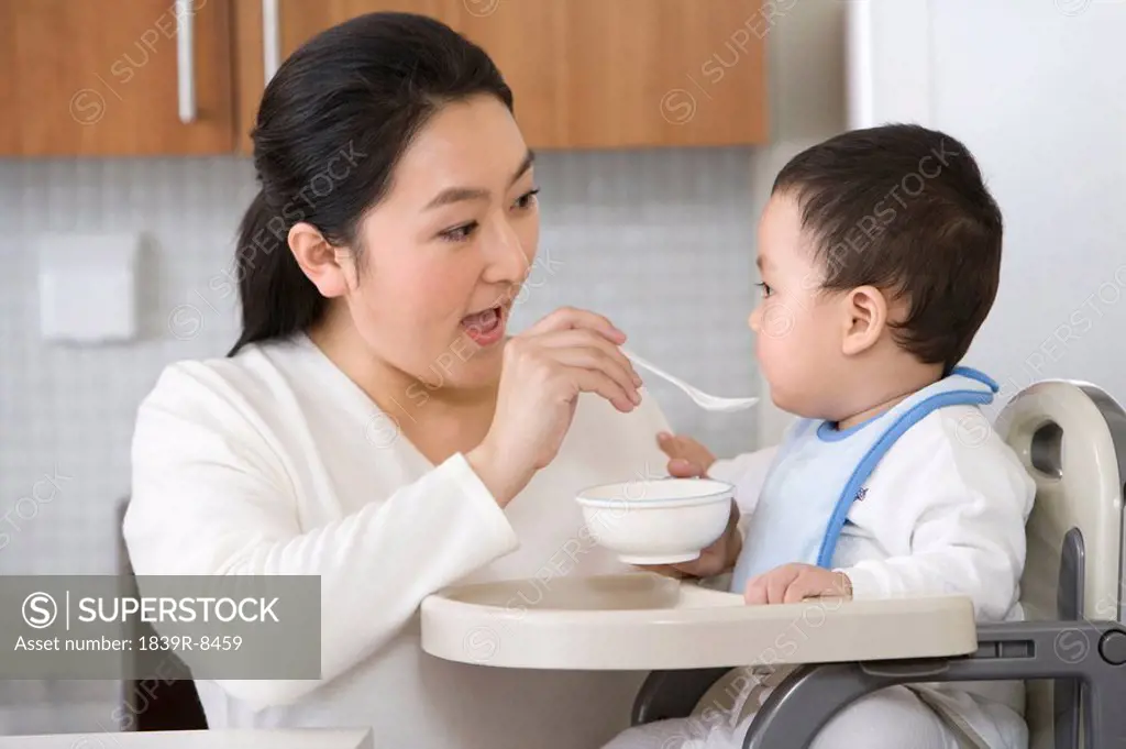 Woman feeding infant