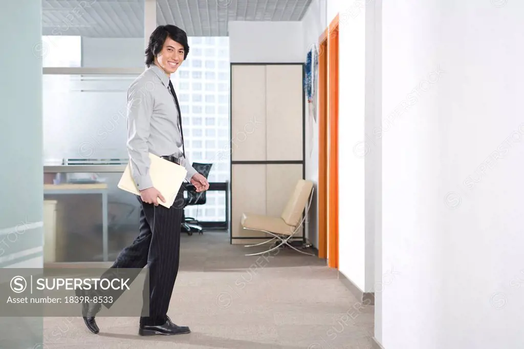 Young businessman walks through office